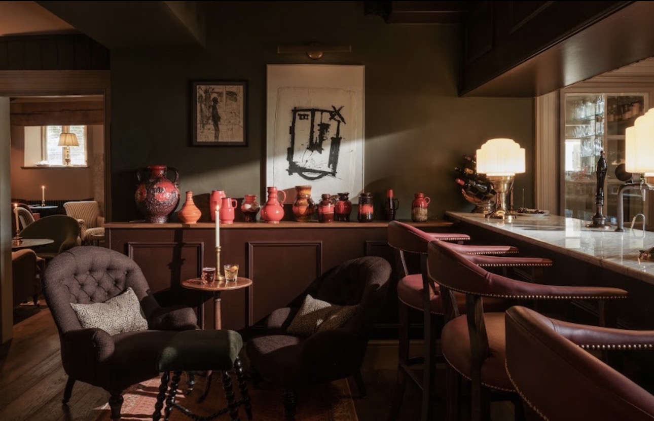 The bar at Teffont House, Teffont Evias: leather stools, deep armchairs and a candlelit collection of pottery
